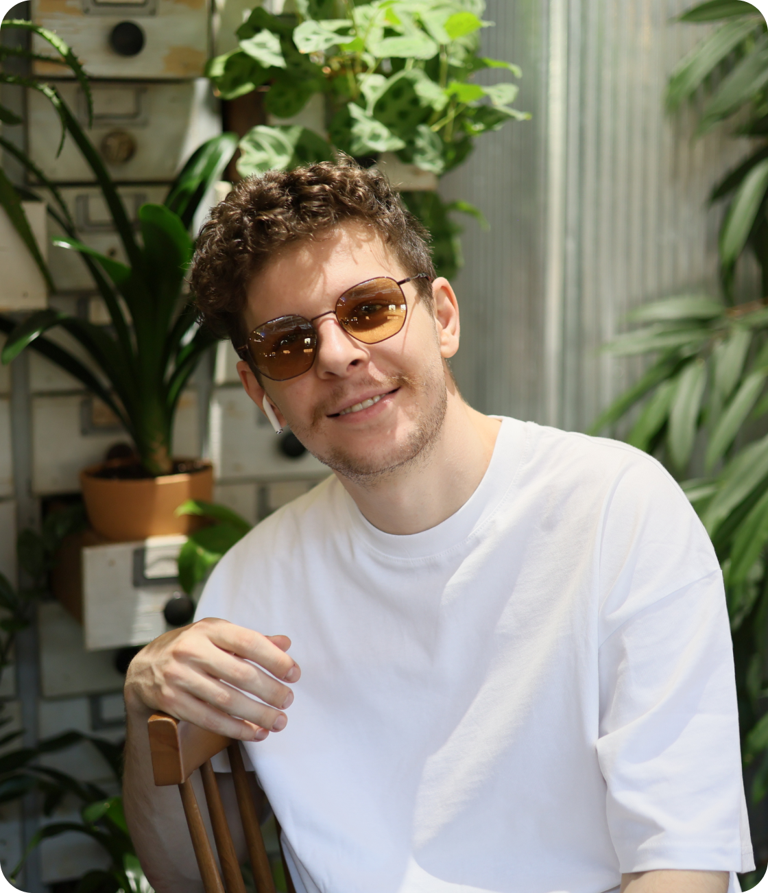 Man in yellow sweatshirt on a dark gray background
